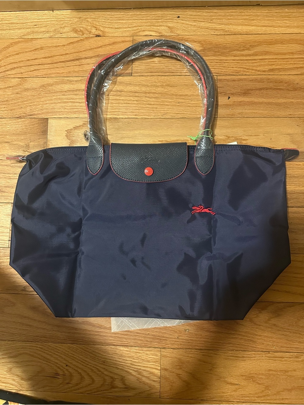 Longchamp Navy Tote with Red Trim and Embroidered Accent